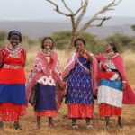 a group of women standing next to each other in a field